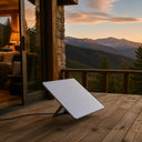 Portable satellite antenna set up on a cabin deck at sunset